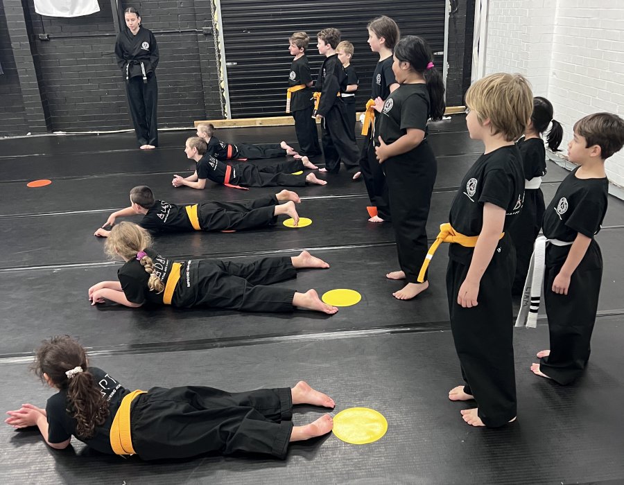 Children having fun doing a warm up for martial arts